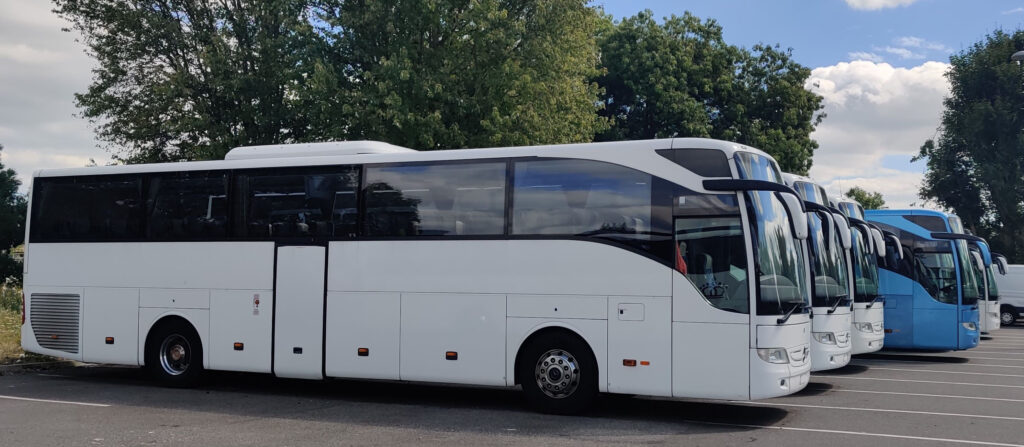 White coaches lined up for a group tour